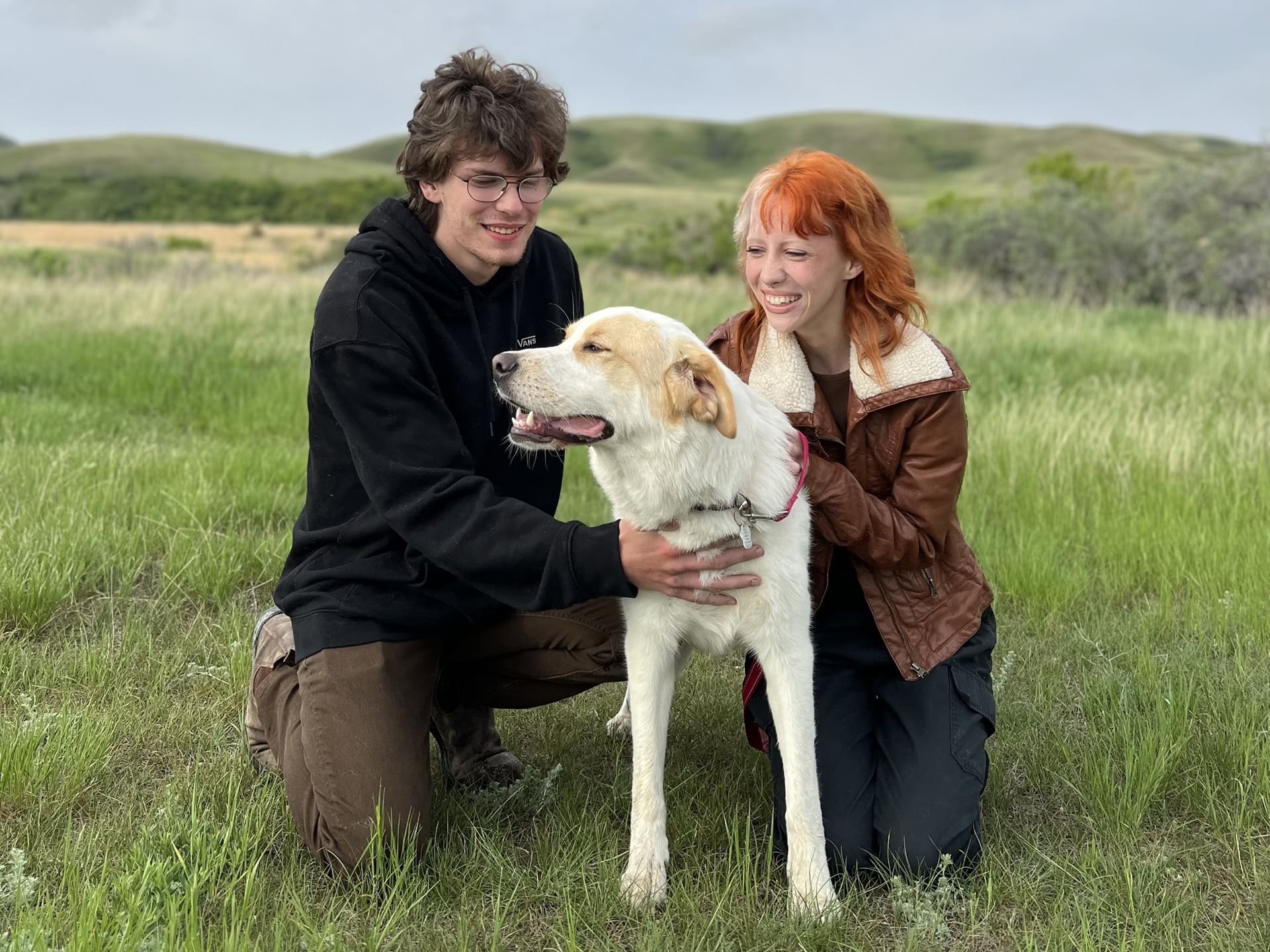 man and woman with their foster dog man and woman with their foster dog